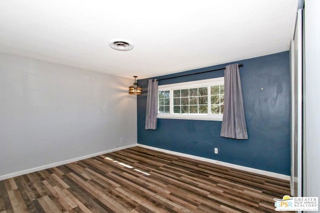 spare room with dark wood-type flooring