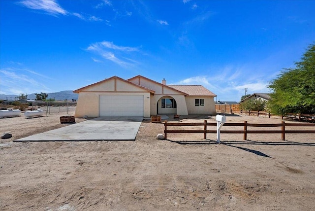 view of front of home with a mountain view and a garage