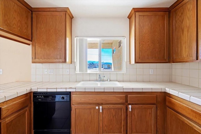 kitchen featuring decorative backsplash, tile counters, dishwasher, and sink