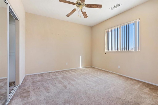 empty room featuring light carpet and ceiling fan