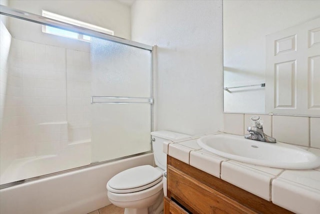 full bathroom featuring vanity, toilet, and enclosed tub / shower combo