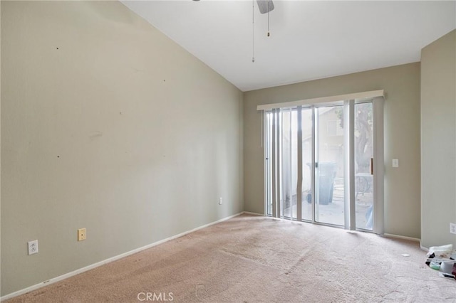 unfurnished room featuring light carpet, vaulted ceiling, and ceiling fan