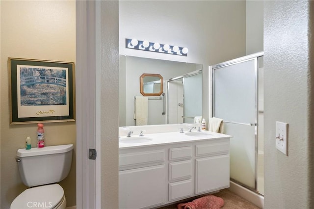 bathroom with vanity, toilet, and walk in shower