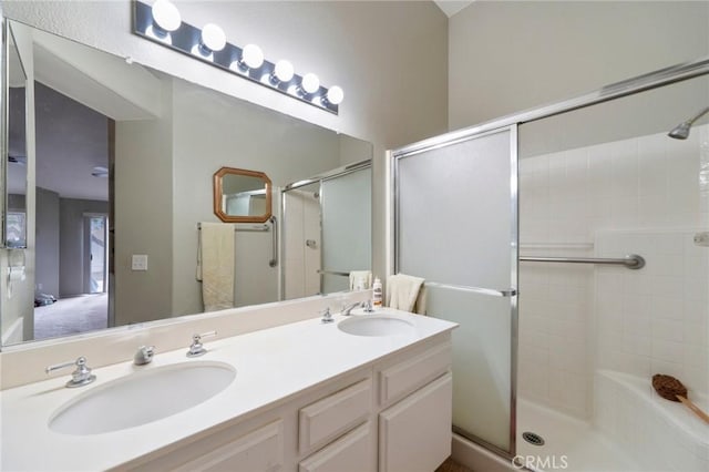 bathroom featuring vanity and a shower with shower door