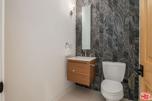 bathroom with tile patterned floors, vanity, and toilet