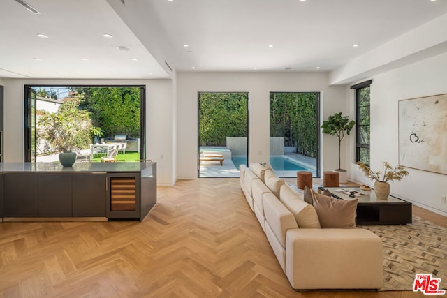 living room with beverage cooler and light parquet flooring