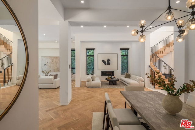 living room with a chandelier and light parquet floors