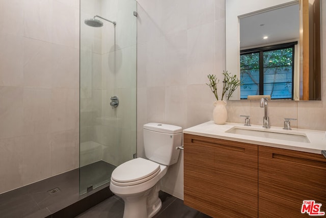 bathroom featuring backsplash, vanity, tile walls, and toilet