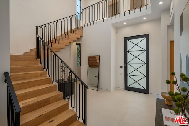 foyer featuring a towering ceiling