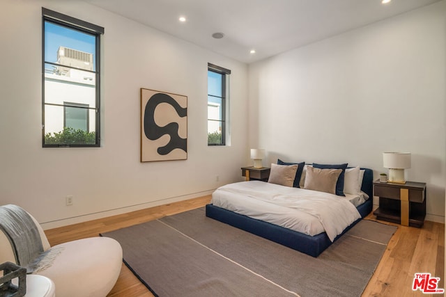 bedroom with hardwood / wood-style floors