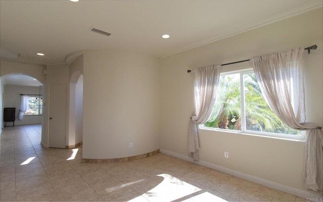 unfurnished room featuring light tile patterned floors