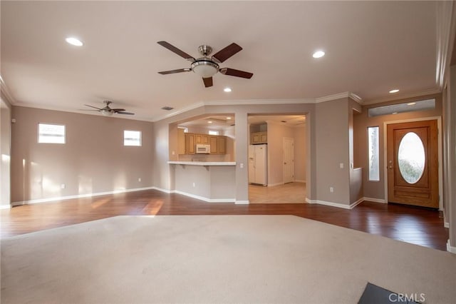 interior space featuring ceiling fan, wood-type flooring, and ornamental molding