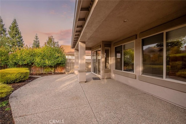 view of patio terrace at dusk