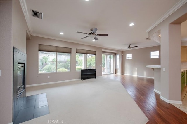 unfurnished living room with ceiling fan, light hardwood / wood-style floors, and ornamental molding