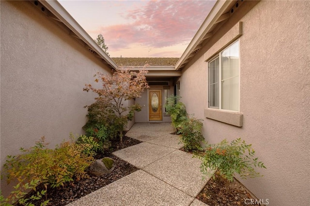 exterior entry at dusk with a patio area