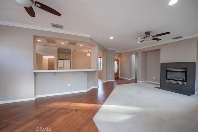 unfurnished living room featuring crown molding, hardwood / wood-style floors, and ceiling fan