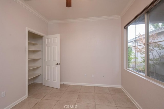 unfurnished bedroom with crown molding, light tile patterned flooring, and ceiling fan