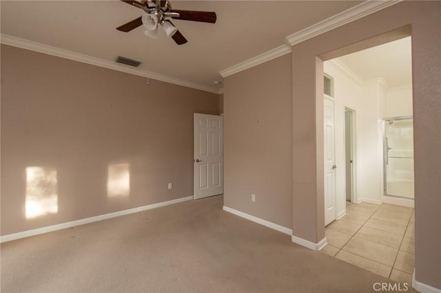 empty room featuring ceiling fan, crown molding, and light carpet