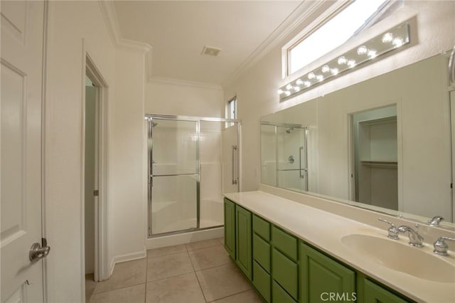 bathroom with vanity, tile patterned floors, a shower with shower door, and crown molding