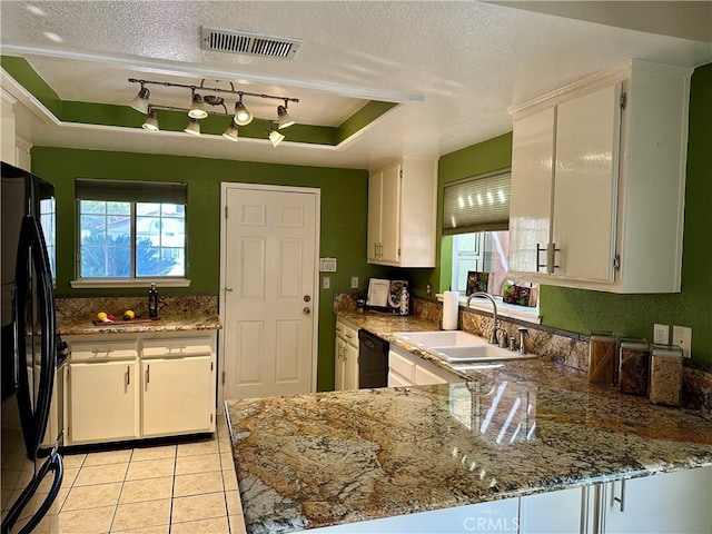 kitchen featuring black appliances, white cabinets, sink, a textured ceiling, and a tray ceiling