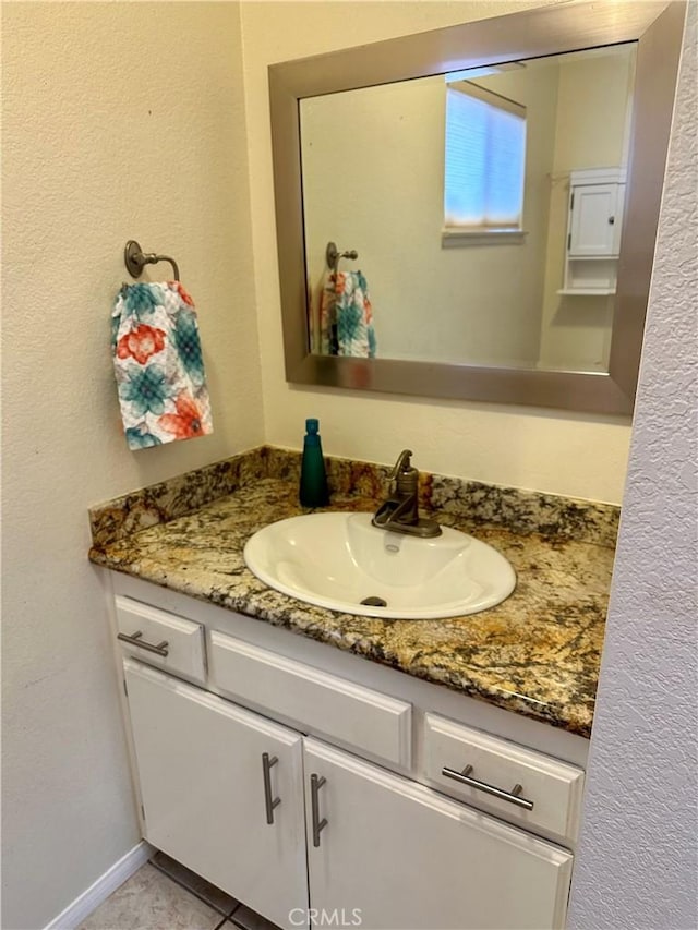 bathroom featuring tile patterned flooring and vanity