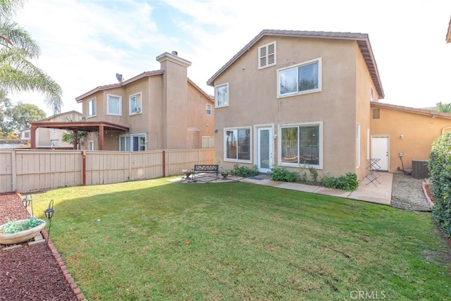 197 Lydia Ln, Corona, CA 92882 - back of house featuring stucco siding, central AC unit, and a patio area