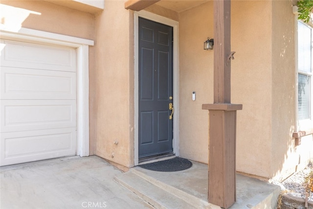 view of exterior entry featuring a garage