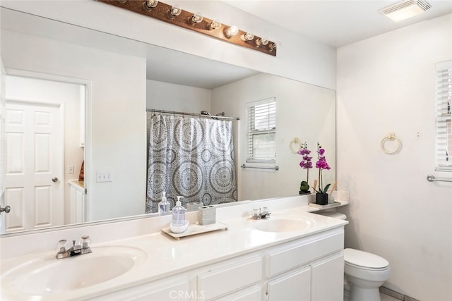 197 Lydia Ln, Corona, CA 92882 - full bathroom featuring toilet, double vanity, and a shower with shower curtain