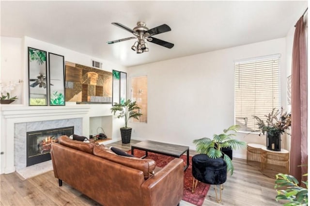 197 Lydia Ln, Corona, CA 92882 - living room with a fireplace, wood finished floors, ceiling fan, and baseboards