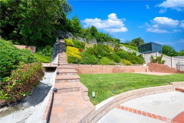 surrounding community with a patio and a lawn