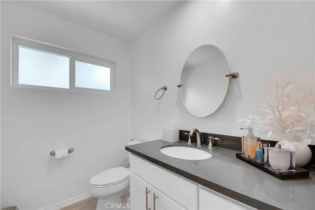 bathroom featuring vanity and toilet