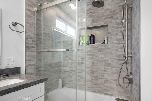 bathroom featuring vanity and bath / shower combo with glass door