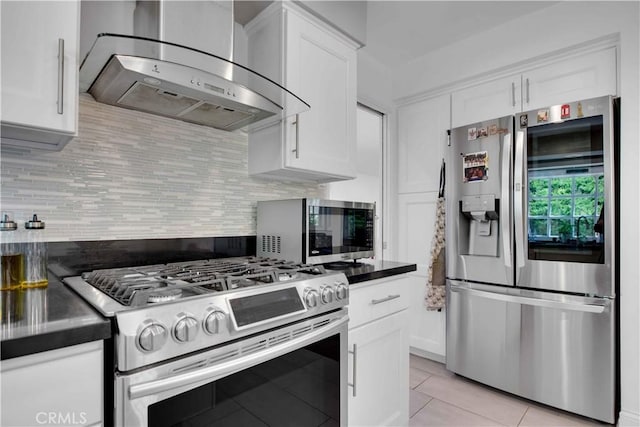 kitchen featuring white cabinets, stainless steel appliances, wall chimney exhaust hood, and light tile patterned flooring