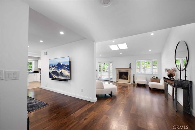 living room with vaulted ceiling and dark hardwood / wood-style floors