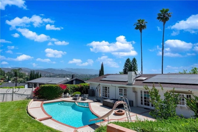 view of swimming pool with a mountain view, french doors, and a patio