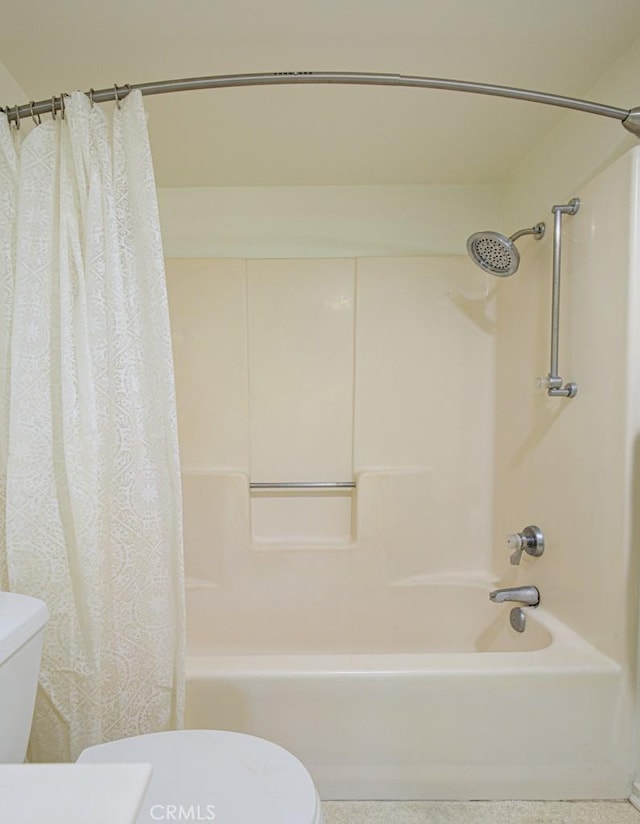 bathroom with toilet and shower / tub combo with curtain