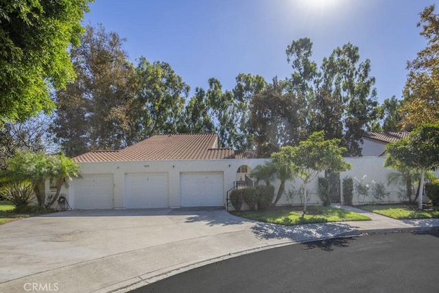 mediterranean / spanish home with a garage