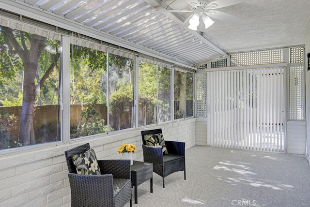 sunroom with ceiling fan and vaulted ceiling