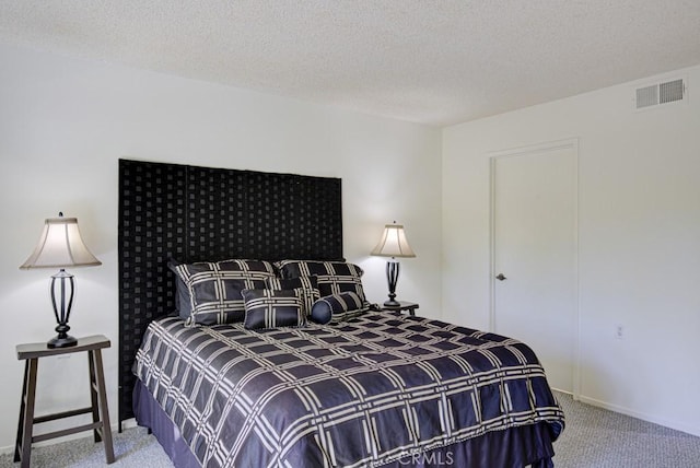 carpeted bedroom featuring a textured ceiling