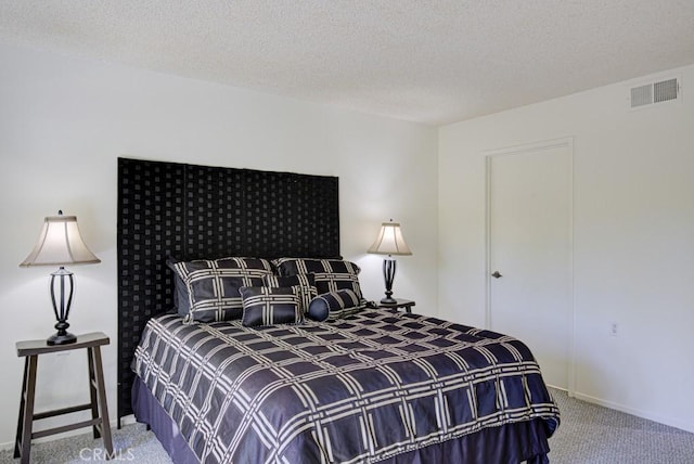 carpeted bedroom with a textured ceiling and visible vents