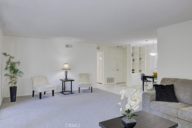 living room featuring carpet and a textured ceiling