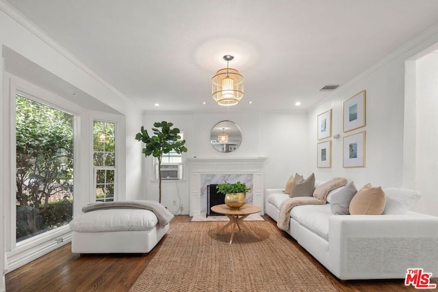 living room featuring cooling unit, dark hardwood / wood-style flooring, ornamental molding, and a fireplace