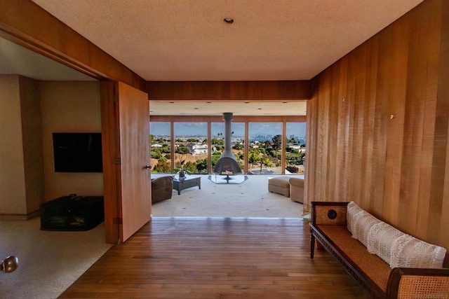 hallway with hardwood / wood-style flooring and wood walls