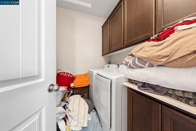 laundry room with cabinets and separate washer and dryer