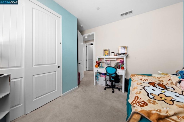 bedroom featuring light carpet and a closet