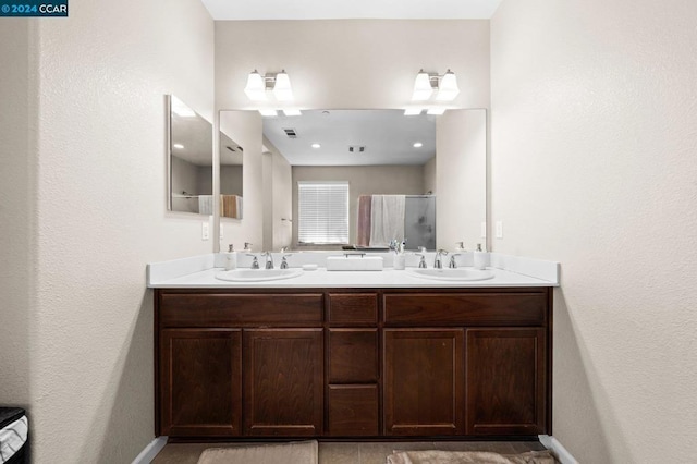 bathroom featuring vanity and an enclosed shower