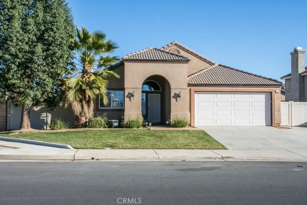 view of front of property with a front lawn and a garage