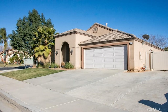 mediterranean / spanish-style home with a garage