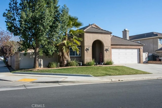 view of front of home with a front lawn and a garage