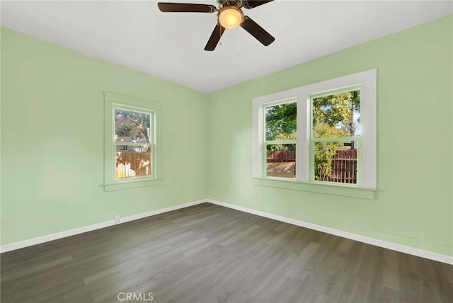 empty room with ceiling fan and dark wood-type flooring